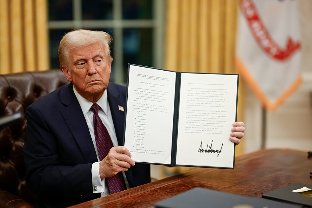 President Donald Trump signs executive orders in the Oval Office on January 20, 2025, during his Inauguration Day