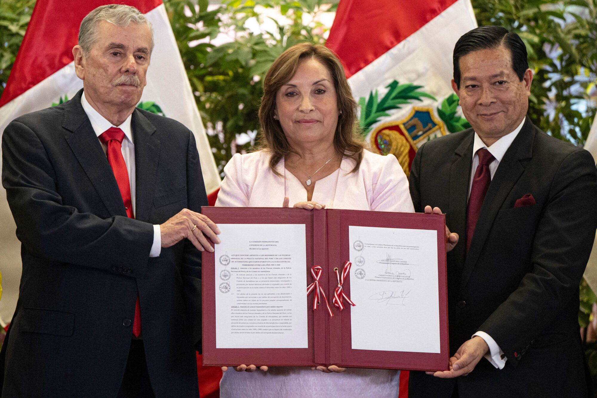 Peru's President Dina Boluarte, center, in Lima after signing bill No. 366 of 2023 into law. (Ernesto Benavides/AFP/Getty Images)